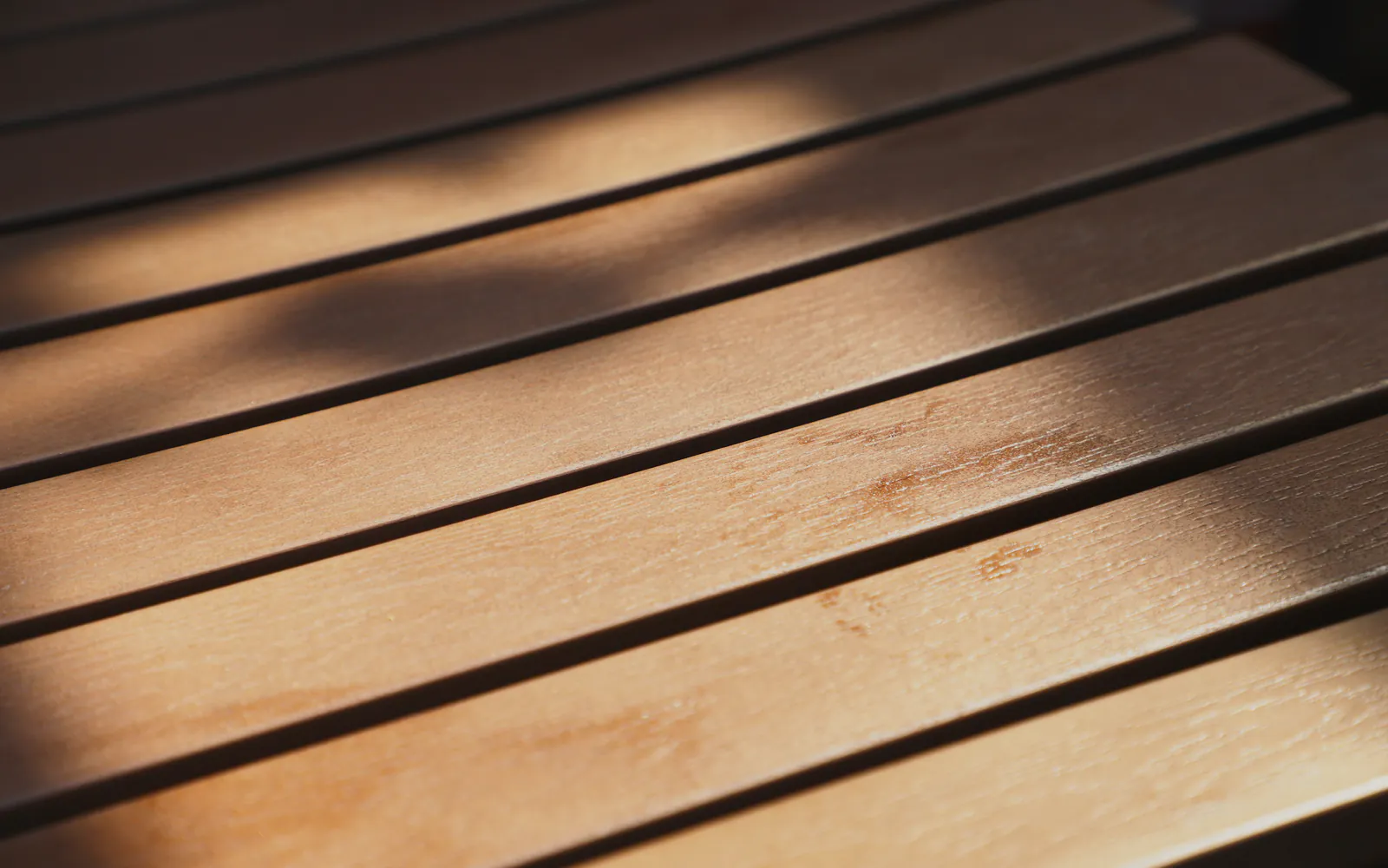 Sun and shadow across timber slats