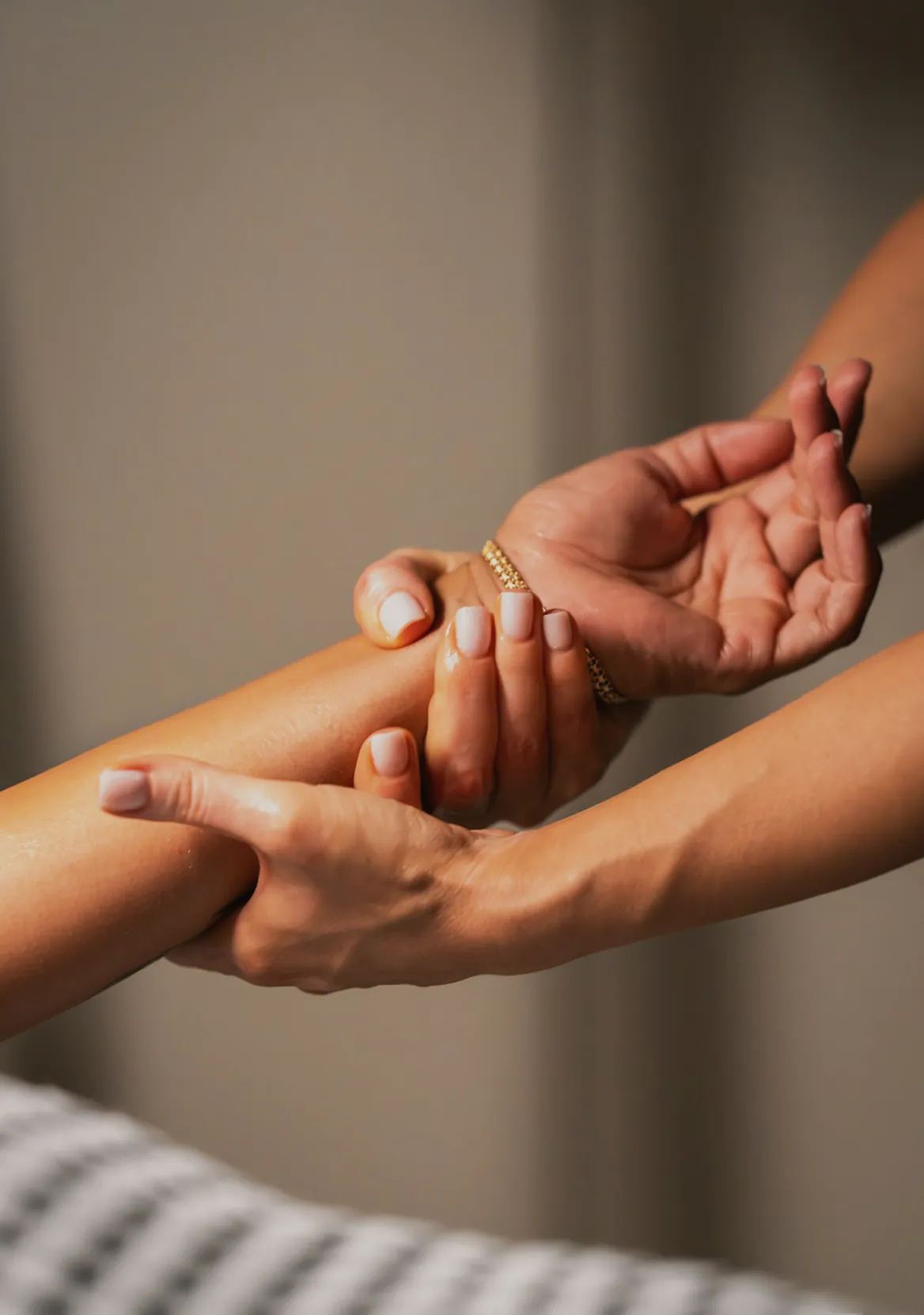 Hands supporting a forearm